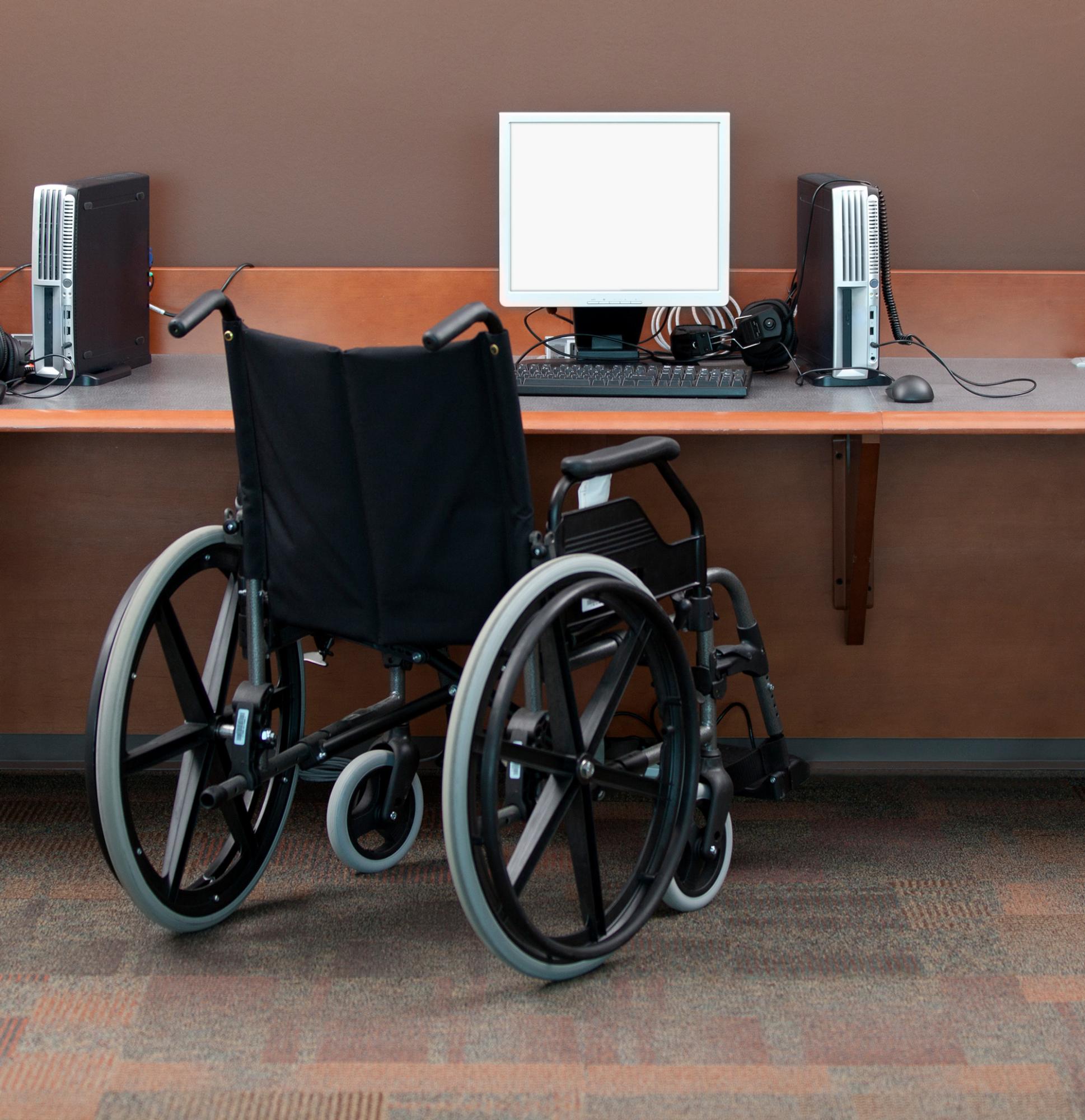 Wheelchair in front of a desktop computer