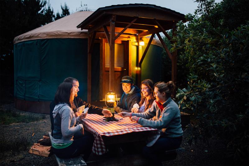 Couples at picnic table with electric lantern